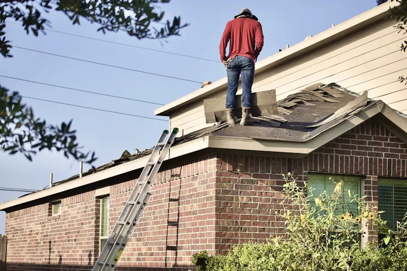 Professional roofer working on a residential roof in Highlands of Olney